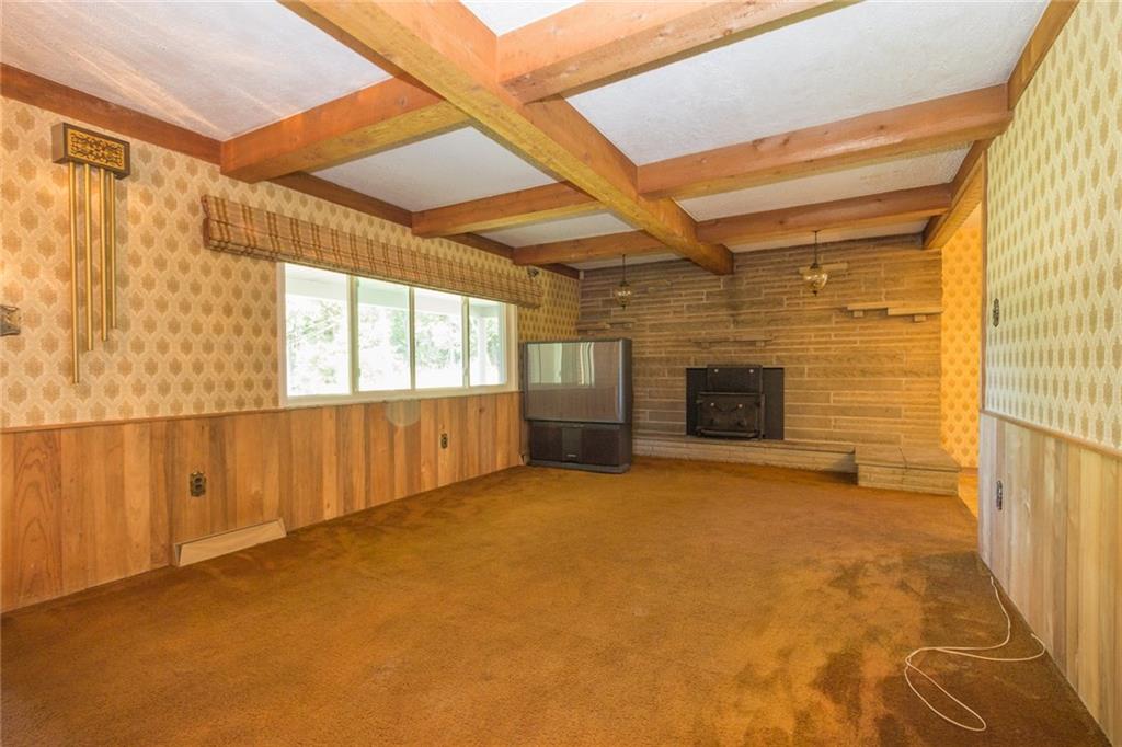 3150 Brodhead Road Aliquippa, PA 15001 - Photo 2 of 19 Large living room in this spacious house! Stone fireplace with wood burner.