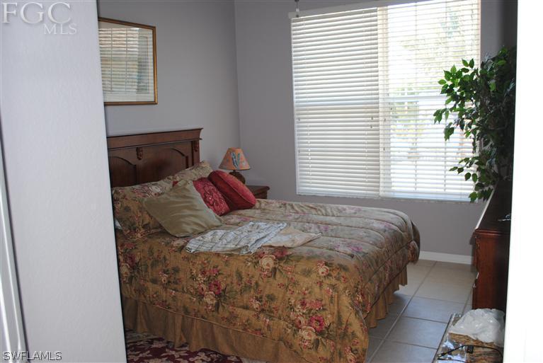 3325 Stringfellow Road, Unit A St. James City, FL 33956 - Photo 12 of 21 a bedroom with a bed and a window