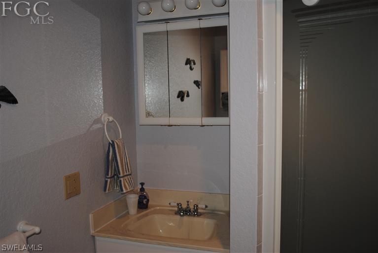 3325 Stringfellow Road, Unit A St. James City, FL 33956 - Photo 13 of 21 a bathroom with a sink and a mirror