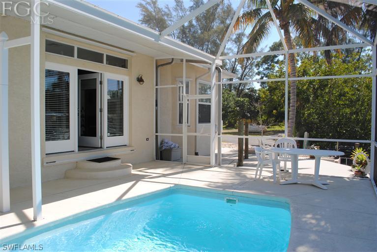 3325 Stringfellow Road, Unit A St. James City, FL 33956 - Photo 15 of 21 a view of a patio with swimming pool table and chairs