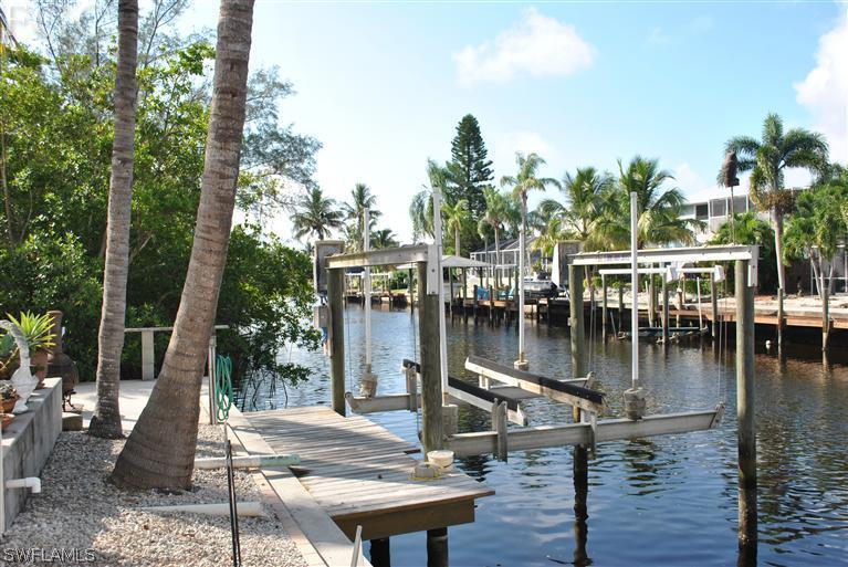 3325 Stringfellow Road, Unit A St. James City, FL 33956 - Photo 20 of 21 a view of a lake with boats in front of house