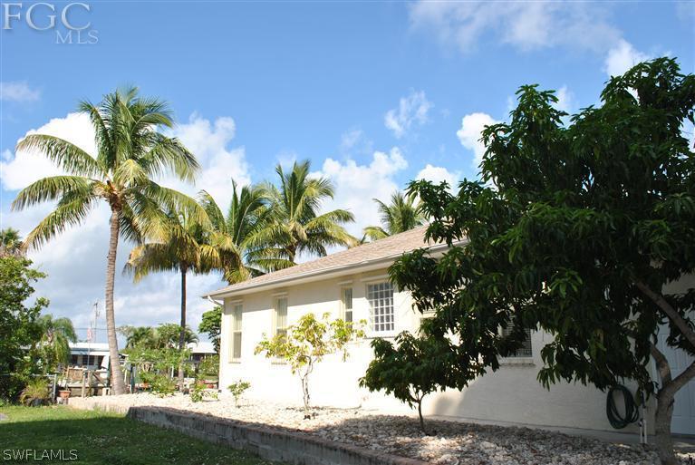 3325 Stringfellow Road, Unit A St. James City, FL 33956 - Photo 21 of 21 a view of a yard with a tree