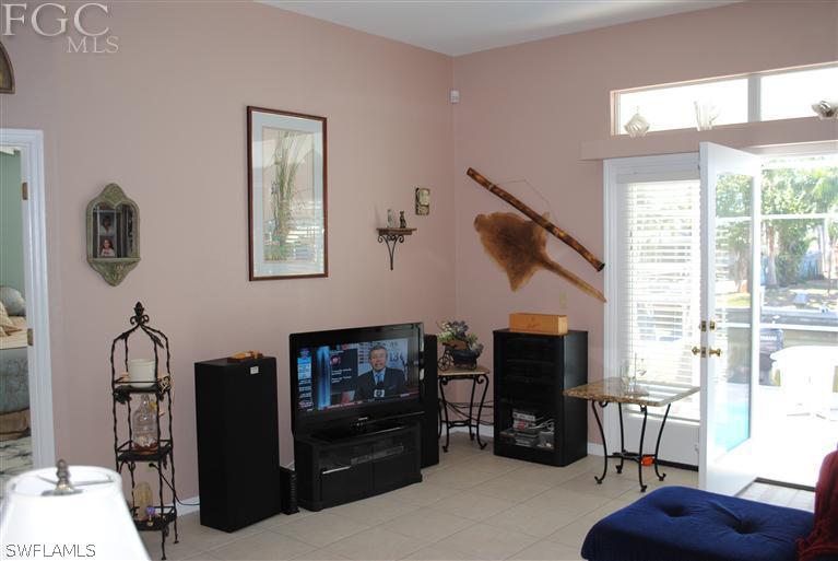 3325 Stringfellow Road, Unit A St. James City, FL 33956 - Photo 3 of 21 a living room with furniture a flat screen tv and a fireplace