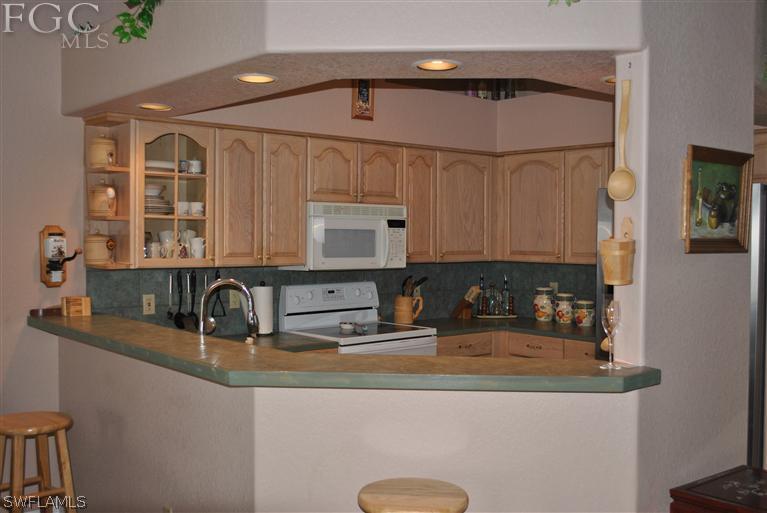3325 Stringfellow Road, Unit A St. James City, FL 33956 - Photo 7 of 21 a kitchen with stainless steel appliances granite countertop a sink and a cabinets