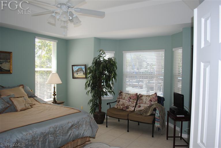 3325 Stringfellow Road, Unit A St. James City, FL 33956 - Photo 9 of 21 a bedroom with a bed and a chair