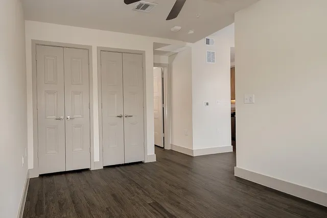a view of an empty room with wooden floor