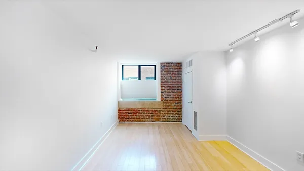 a view of bathroom with sink and wooden floor
