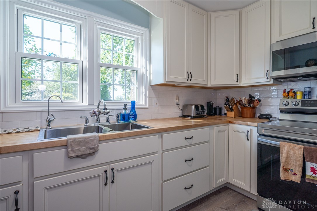 1599 Garringer Road Jamestown, OH 45335 - Photo 13 of 73 This charming kitchen features elegant cabinetry and abundant natural light, creating a bright and inviting atmosphere.