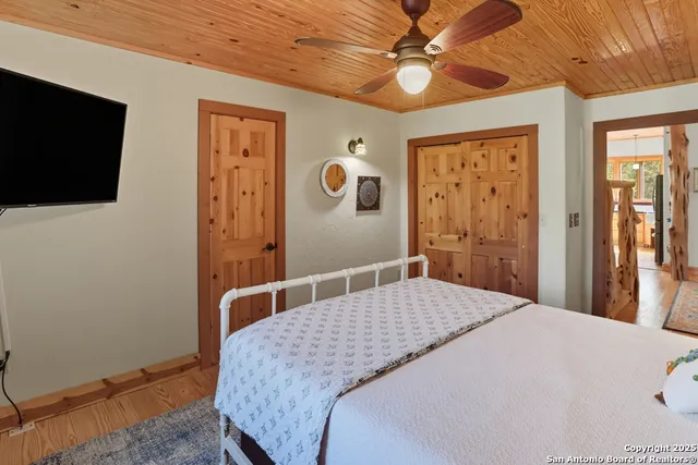 a bedroom with a bed and a flat screen tv