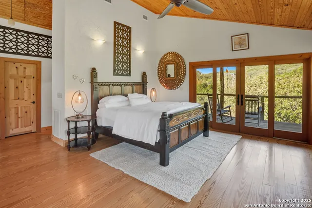 a bedroom with a bed next to a window with outer view