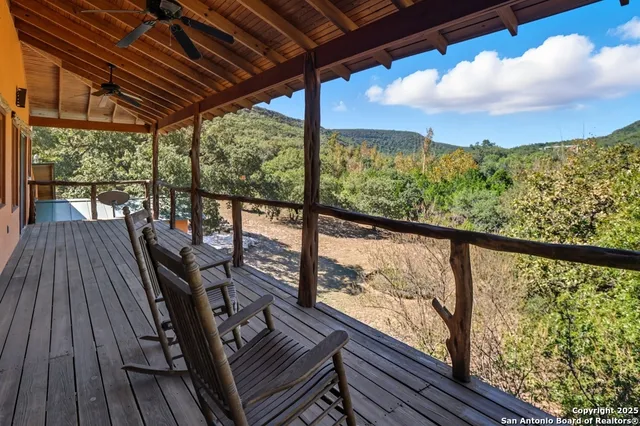 a view of a balcony with wooden floor