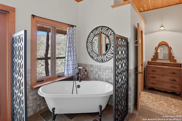 a bathroom with a bathtub and a sink