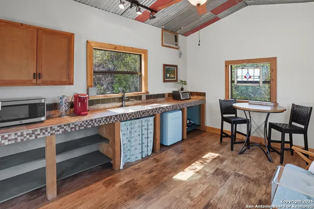 a kitchen with stainless steel appliances granite countertop a stove a sink dishwasher and cabinets with wooden floor