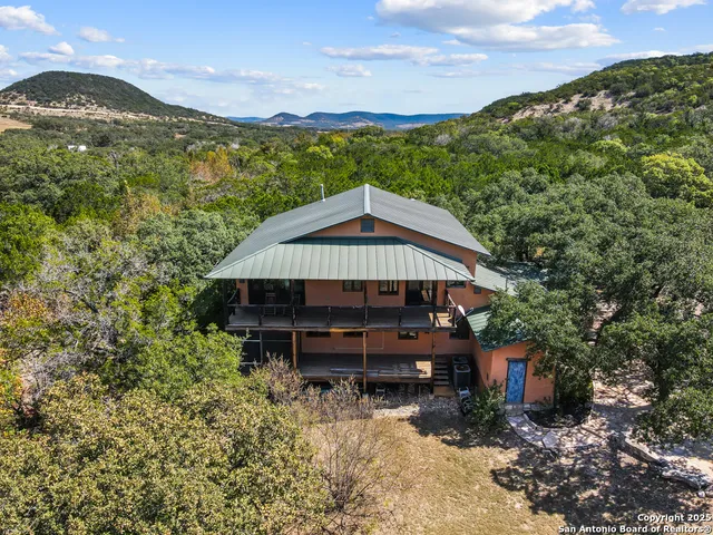 a view of a house with a yard and sitting area