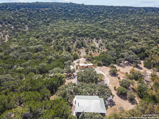 an aerial view of house with yard and mountain view
