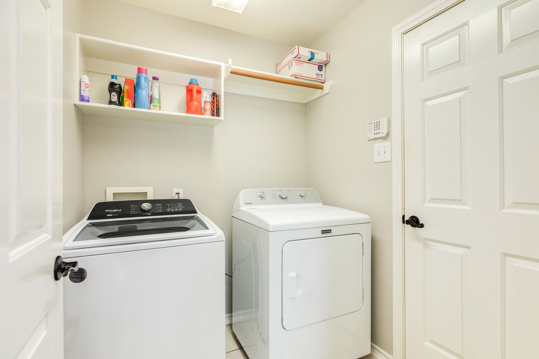 13808 Stark Bridge Lane Rosharon, TX 77583 - Photo 24 of 39 Spacious laundry room featuring full-size washer and dryer, convenient garment hanging rack, and integrated storage shelving. This functional space also provides direct interior access to the attached two-car garage.