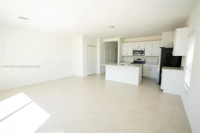 a kitchen with a refrigerator and a sink
