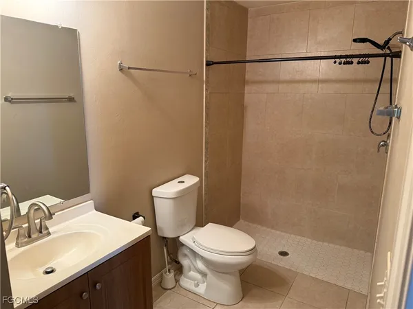 a white toilet sitting next to a bathroom sink