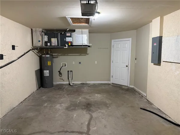 a view of a kitchen with stainless steel appliances granite countertop a refrigerator and a stove