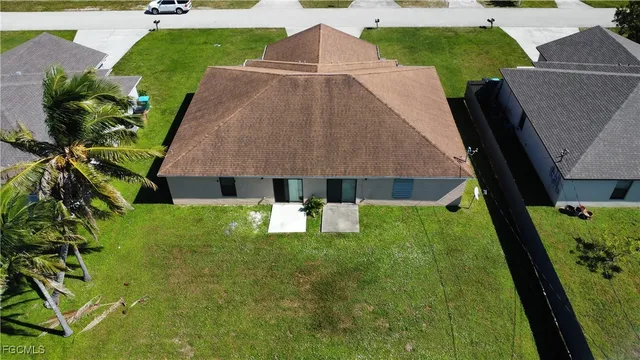 a aerial view of a house with pool