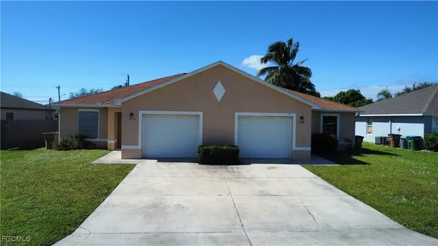 a front view of a house with a yard and garage