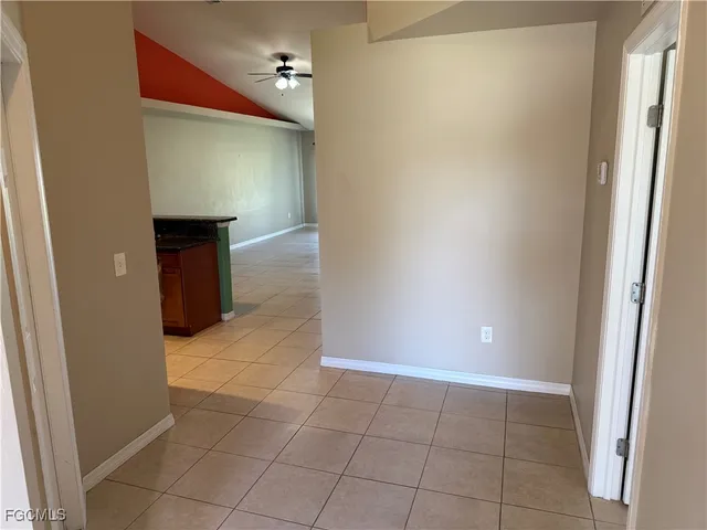 an empty room and an entrance to other room