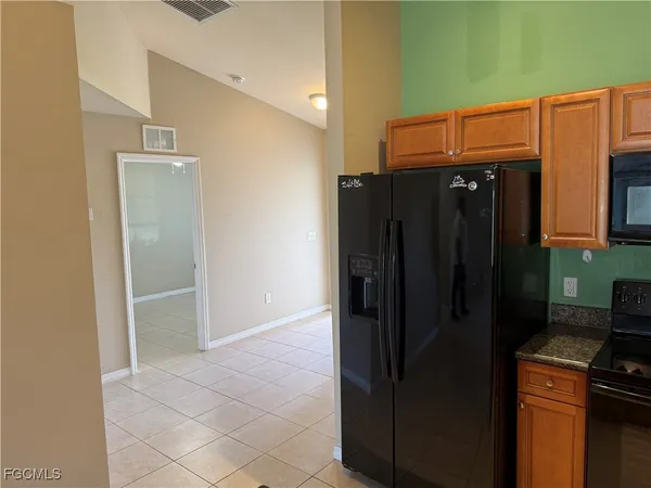 a kitchen with a refrigerator and cabinets