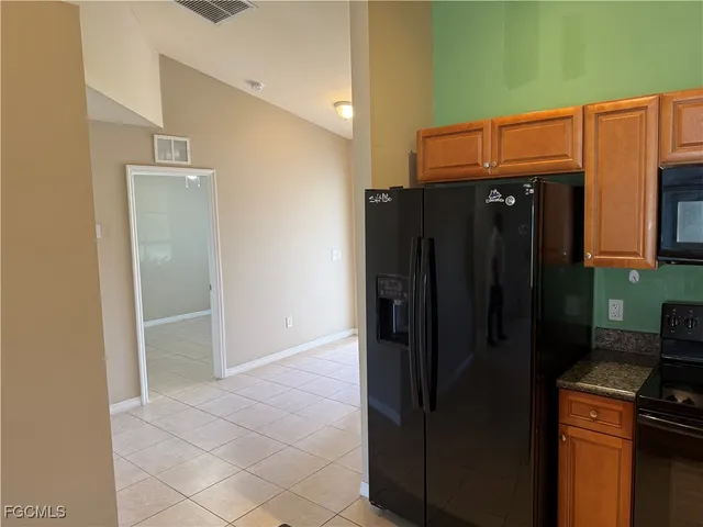 a kitchen with a refrigerator and cabinets