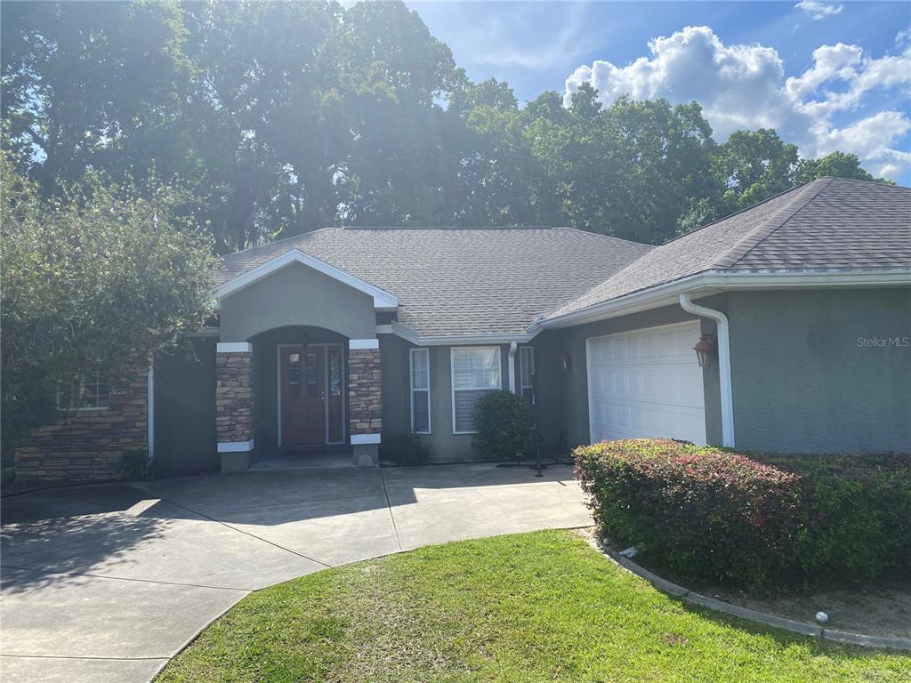 3386 Southwest 10th Terrace Ocala, FL 34471 - Photo 1 of 1 a front view of a house with a yard and garage