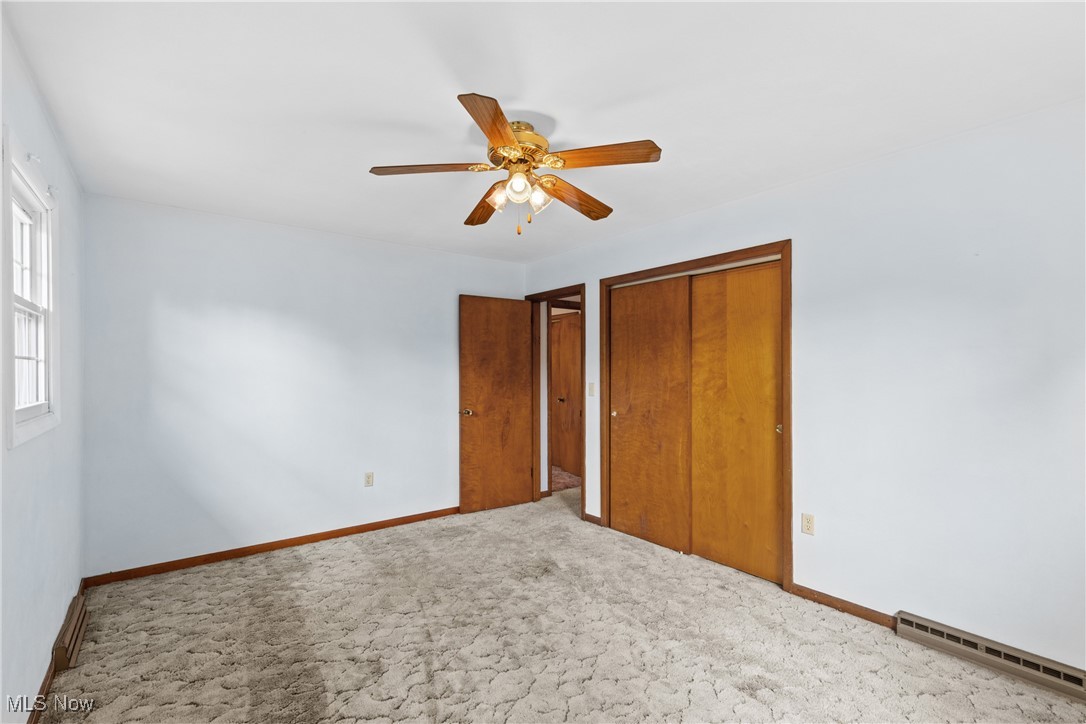 59937 Broadview Road Shadyside, OH 43947 - Photo 22 of 36 Unfurnished bedroom with a baseboard radiator, carpet flooring, a closet, and ceiling fan