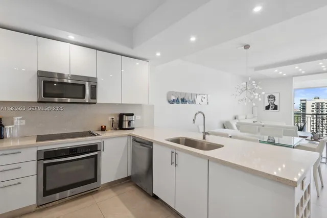 a kitchen with a sink stove and microwave