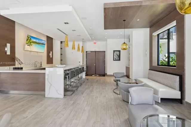a living room with furniture a flat screen tv and a large window