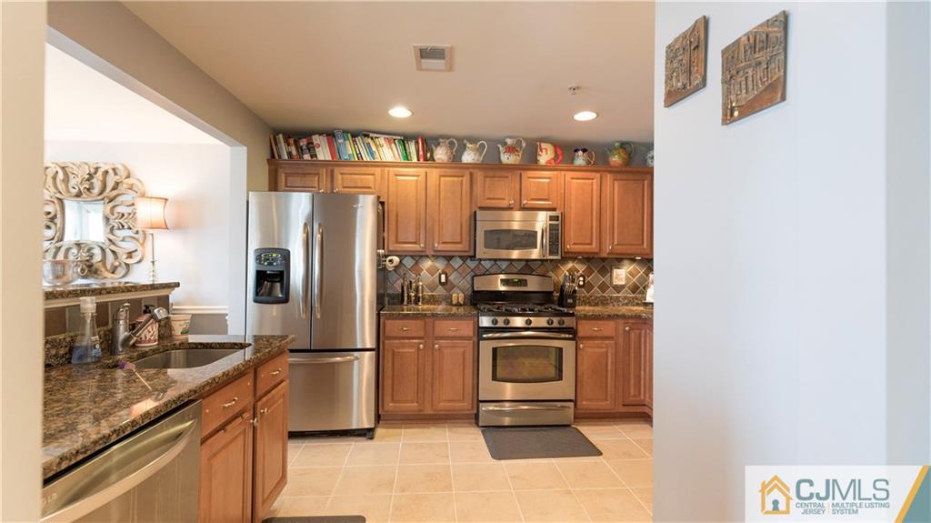 34 Raritan Reach Road, Unit 17 South Amboy, NJ 08879 - Photo 12 of 25 a kitchen with stainless steel appliances granite countertop a refrigerator and a stove
