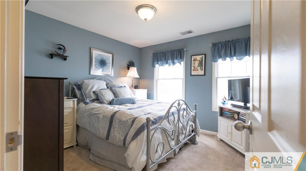 34 Raritan Reach Road, Unit 17 South Amboy, NJ 08879 - Photo 13 of 25 a bedroom with a bed and a flat tv screen