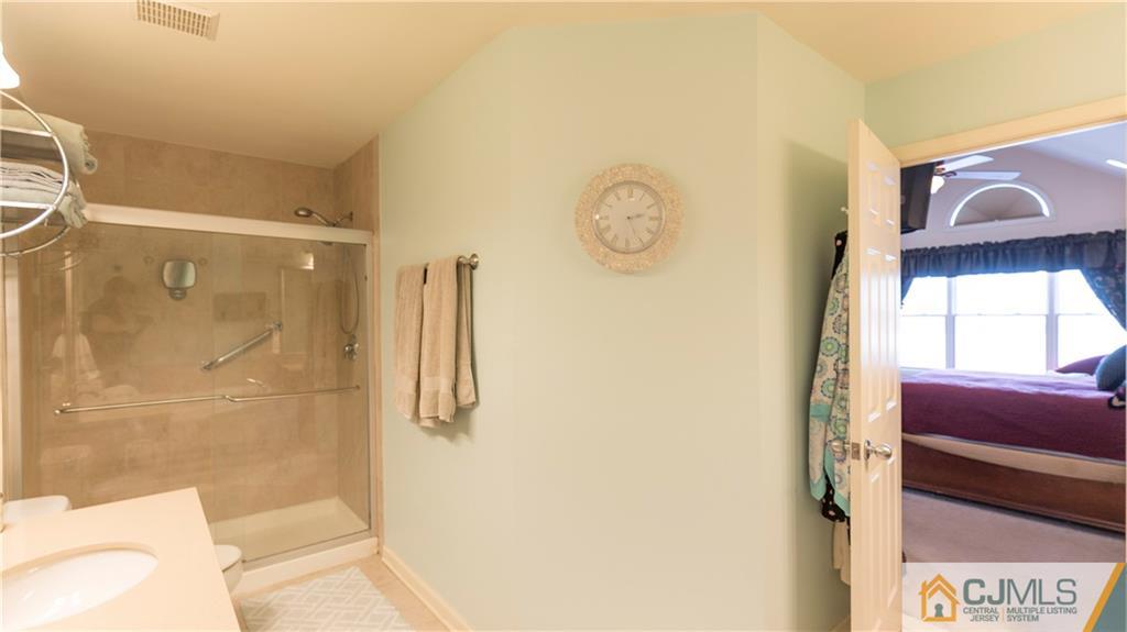 34 Raritan Reach Road, Unit 17 South Amboy, NJ 08879 - Photo 16 of 25 a bathroom with a shower and a mirror