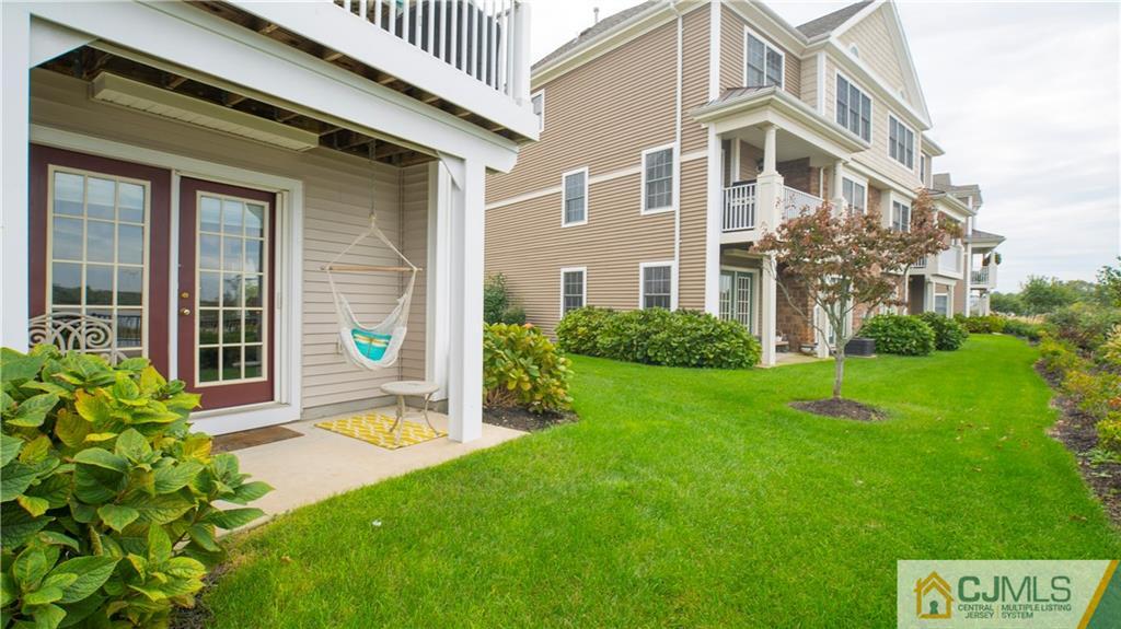 34 Raritan Reach Road, Unit 17 South Amboy, NJ 08879 - Photo 19 of 25 a view of a house with brick walls and a yard with plants