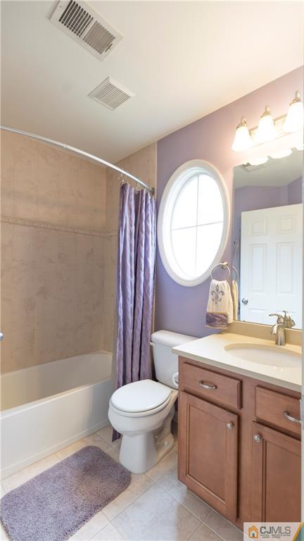 34 Raritan Reach Road, Unit 17 South Amboy, NJ 08879 - Photo 23 of 25 a bathroom with a toilet a sink a mirror and a bathtub