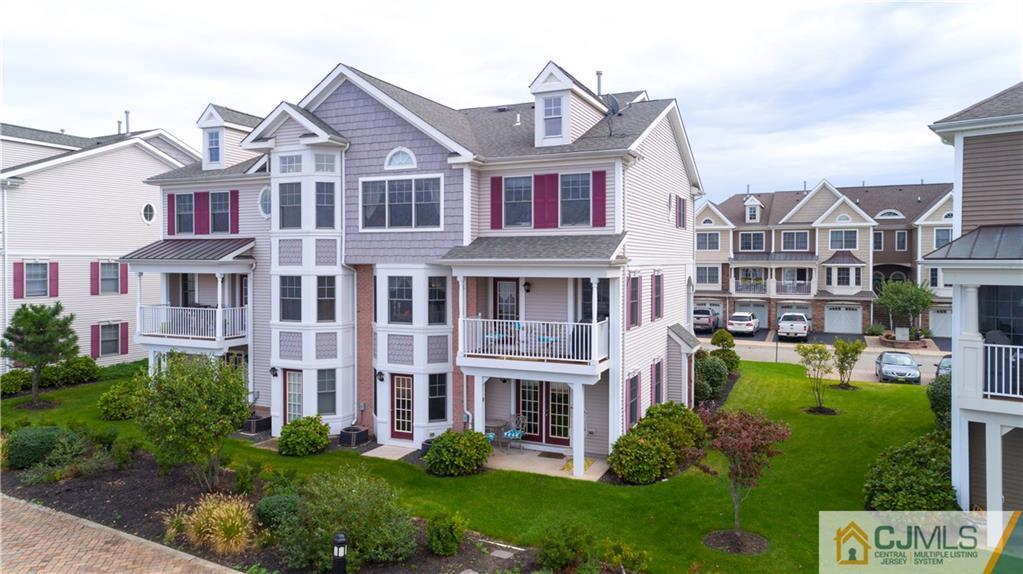 34 Raritan Reach Road, Unit 17 South Amboy, NJ 08879 - Photo 4 of 25 a front view of a residential apartment building with a yard and potted plants
