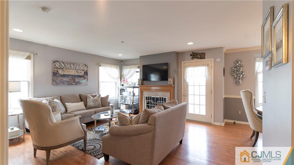34 Raritan Reach Road, Unit 17 South Amboy, NJ 08879 - Photo 8 of 25 a living room with furniture a fireplace and a flat screen tv