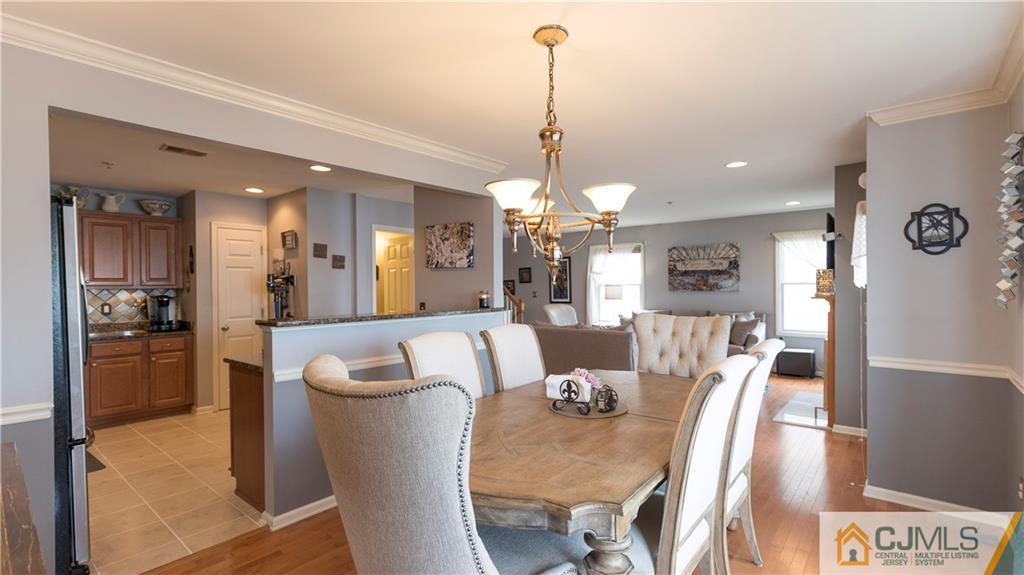34 Raritan Reach Road, Unit 17 South Amboy, NJ 08879 - Photo 10 of 25 a view of a dining room and livingroom with furniture wooden floor a chandelier