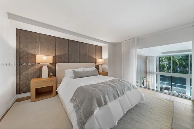 a bedroom with bed and large window