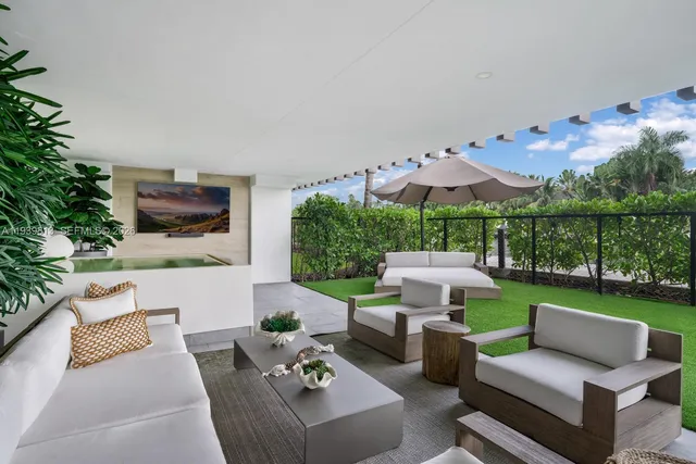 a view of a patio with couches table and chairs with potted plants