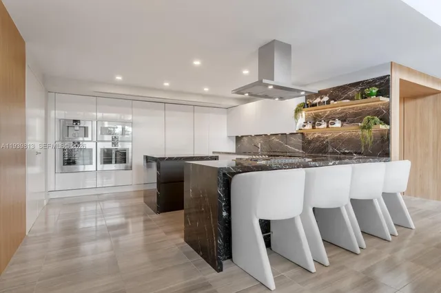 a kitchen with stainless steel appliances kitchen island granite countertop a sink and cabinets