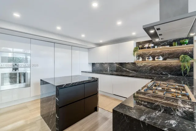a kitchen with stainless steel appliances granite countertop a stove and a refrigerator
