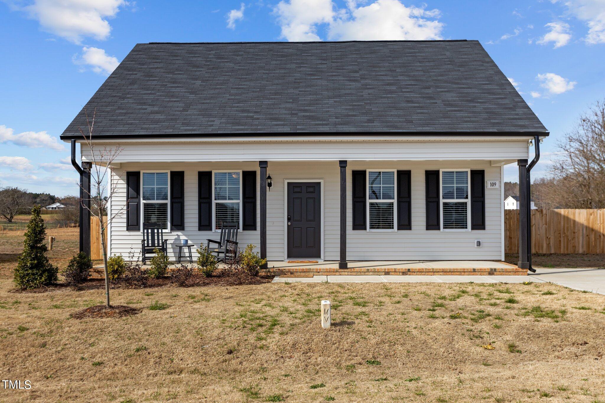 a front view of a house with sitting area