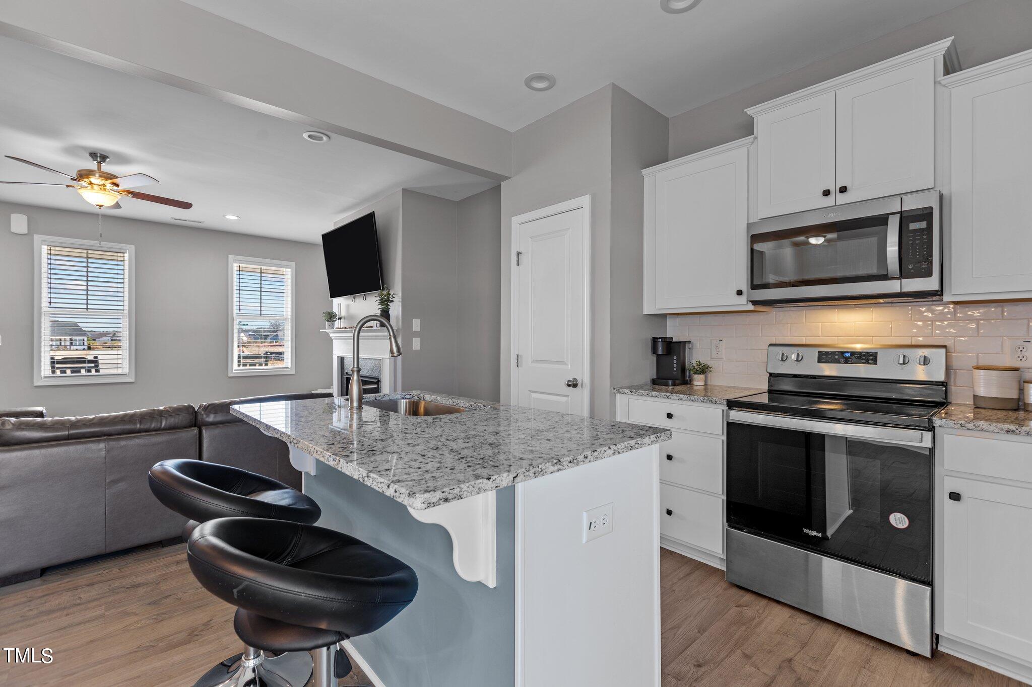 109 Longbow Drive Middlesex, NC 27557 - Photo 9 of 20 a kitchen with stainless steel appliances granite countertop a stove sink and microwave