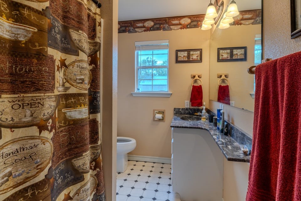 483 Riverside Drive Palacios, TX 77465 - Photo 23 of 41 a bathroom with a sink toilet and shower