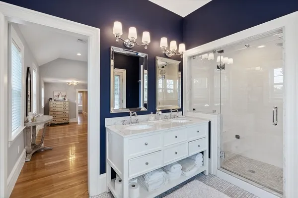 a bathroom with a double vanity sink mirror and shower