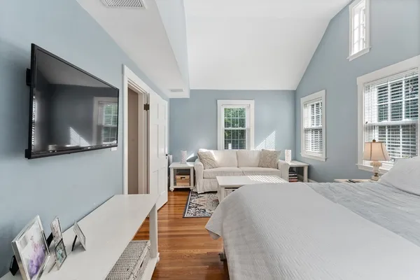 a bedroom with a large bed and a flat screen tv