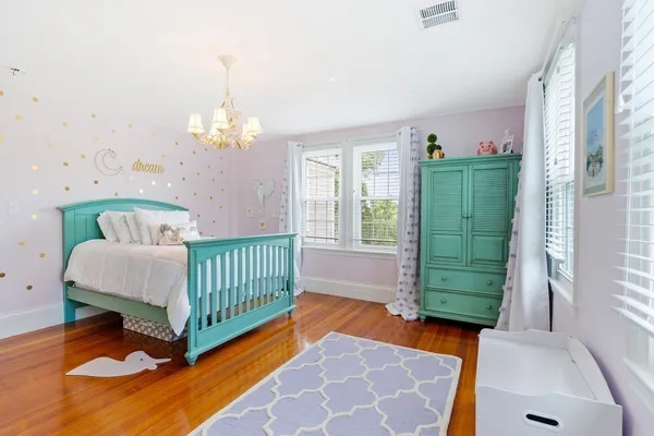 a bedroom with a bed and windows